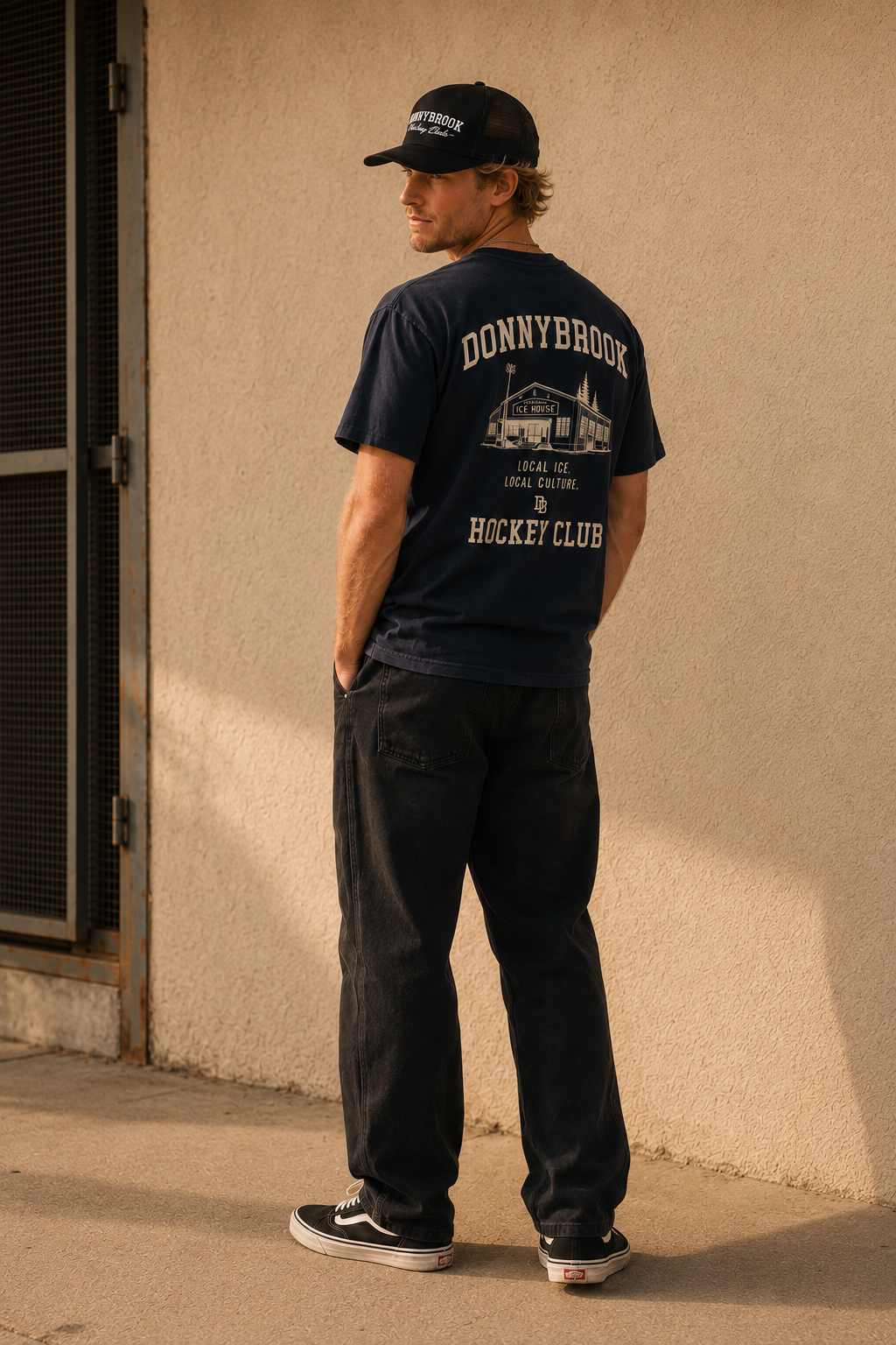 Navy Donnybrook club tee and black cap in a doorway